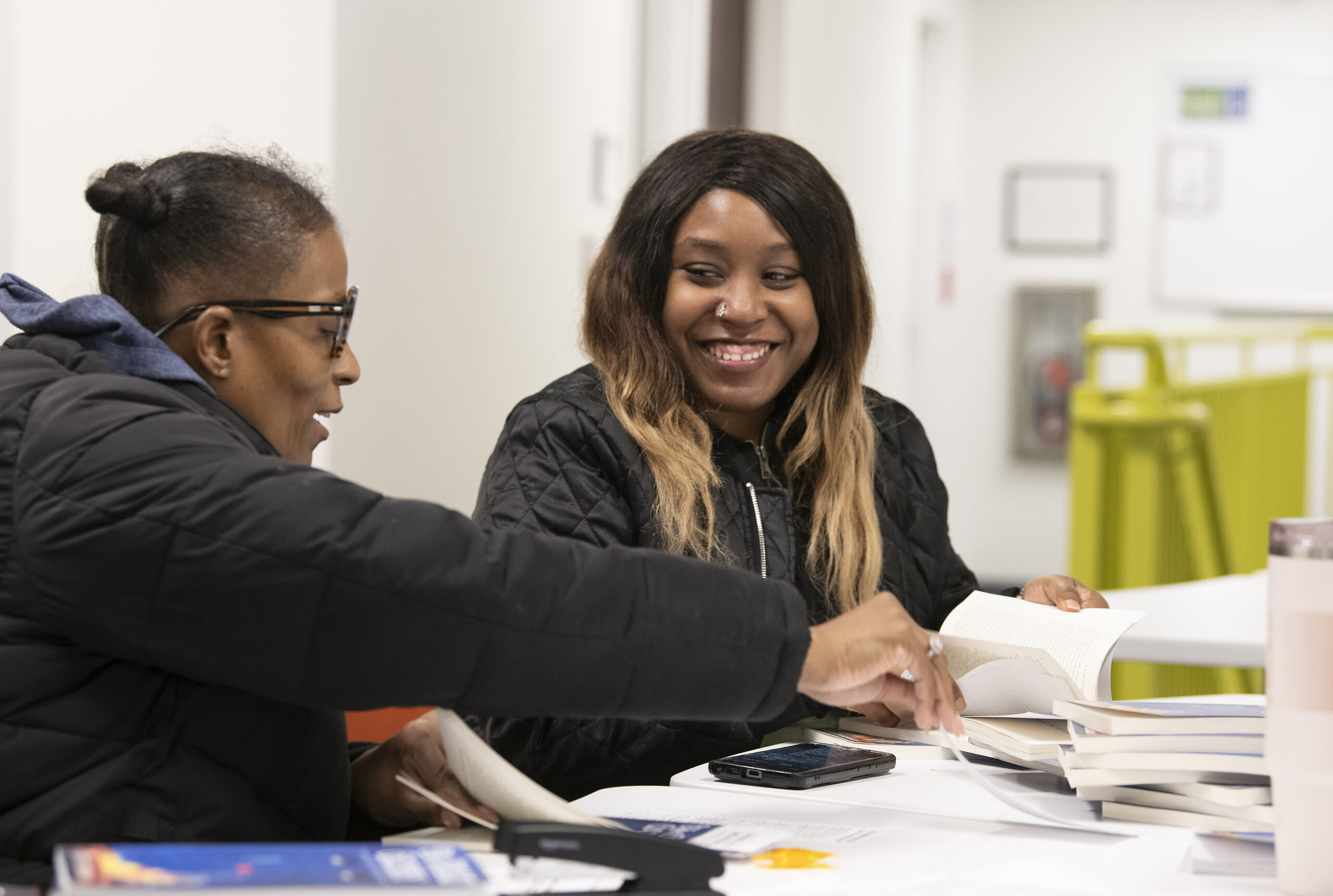 Student smiling in class, working with partner