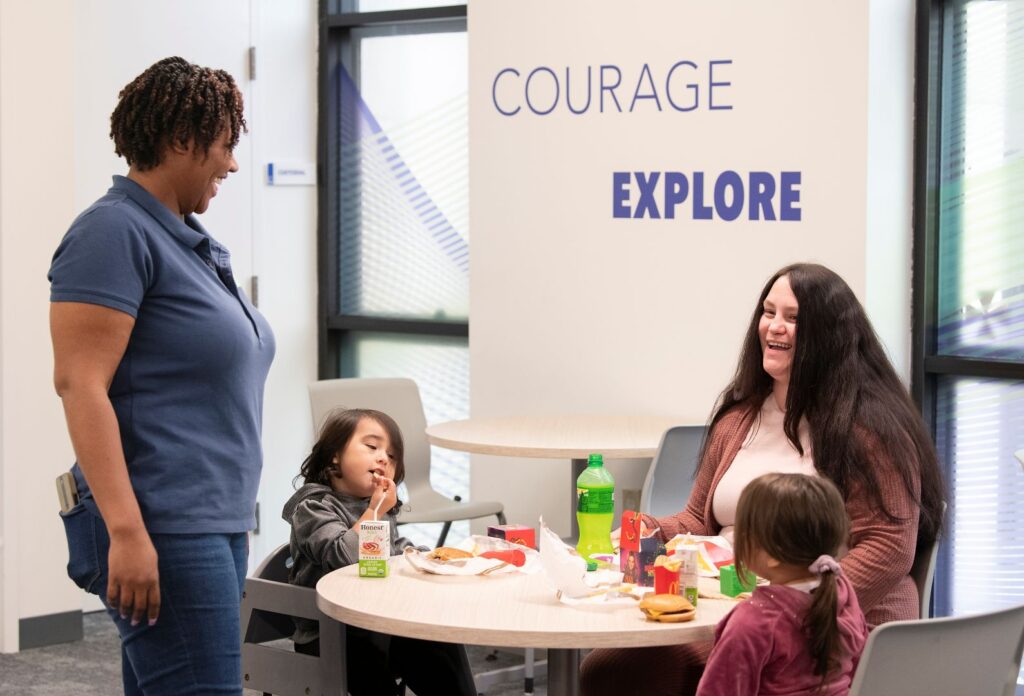 Goodwill_Excel_50 Lounge (5) Student with kids in student lounge talking to staff