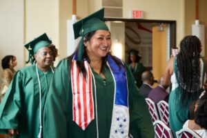 Olivia entering graduation smiling